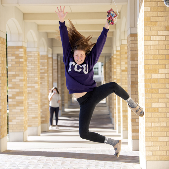 Ӱɴý student jumps for joy in the Commons