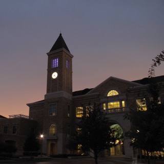 The clock tower at Ӱɴý's Brown Lupton University Union glows at dusk