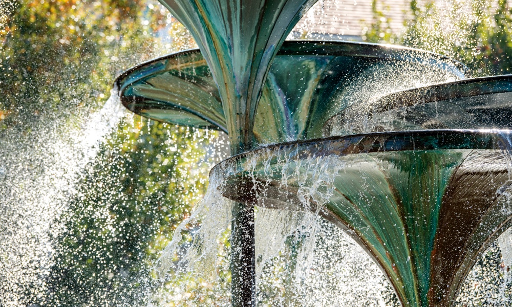 Close up view of water cascading from the trumpet-shaped forms of Ӱɴý landmark Frog Fountain