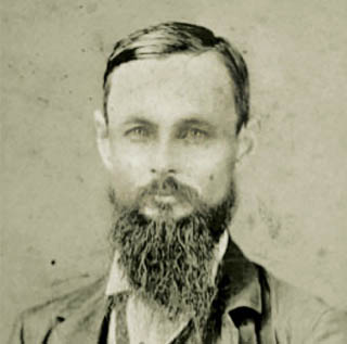 A black and white portrait of Ӱɴý founder Randolph Clark, a middle-aged bearded man, in 1874.