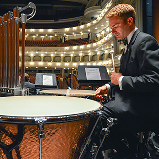 A male Ӱɴý music student in a tuxedo rehearses percussion at Fort Worth's Bass Performance Hall