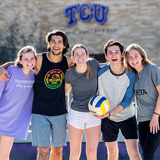 Five Ӱɴý students on the sand volleyball court